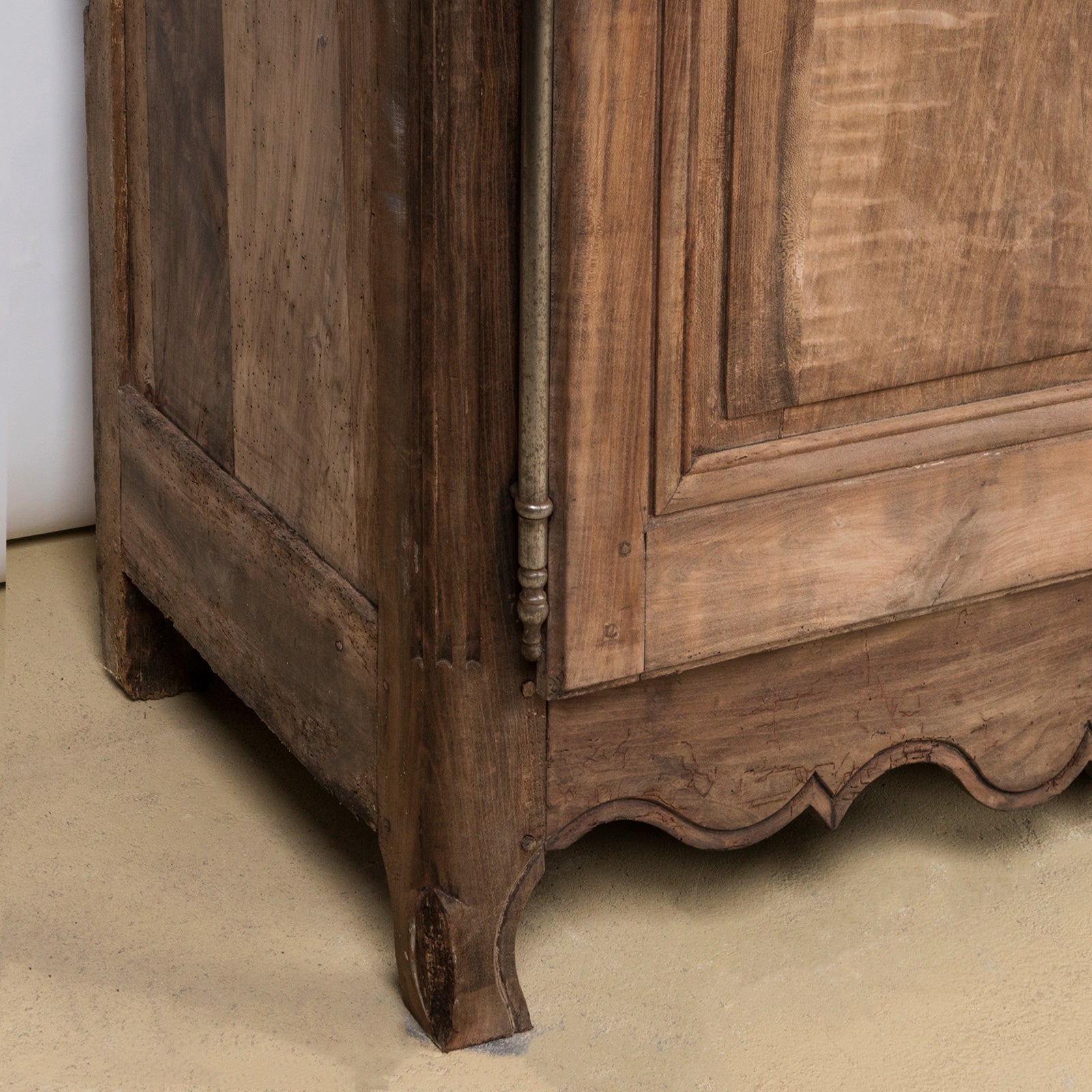 Close-up of a 19th C Antique French Louis XV style armoire with double doors and rustic wooden texture