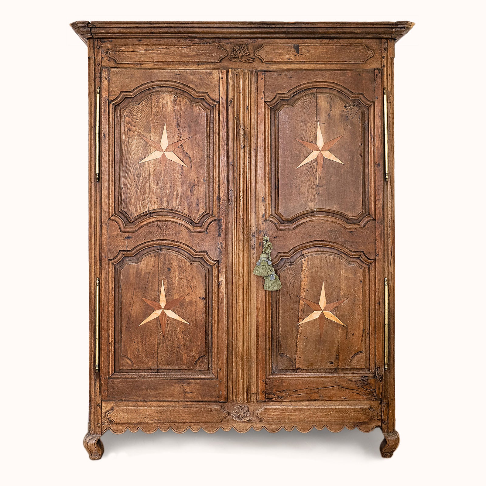Antique French Louis XV style armoire with star shaped inlays on the doors, made of wood with a visible rustic finish, available at Wildschut Antiques