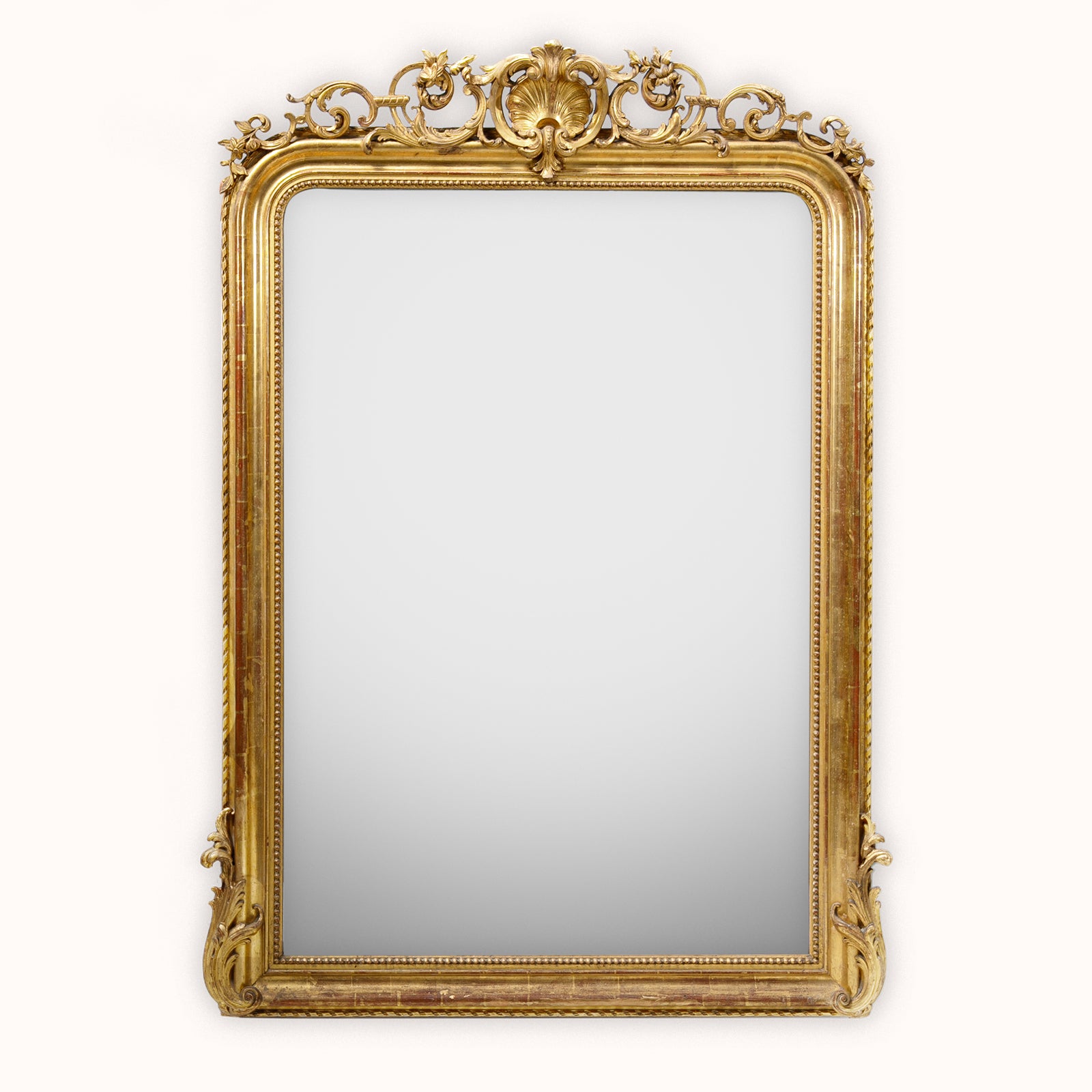 Antique French 19th Century Louis Philippe style gold gilt mirror with shell crest, leaf and flower ornaments, and pearl beading, available at Wildschut Antiques