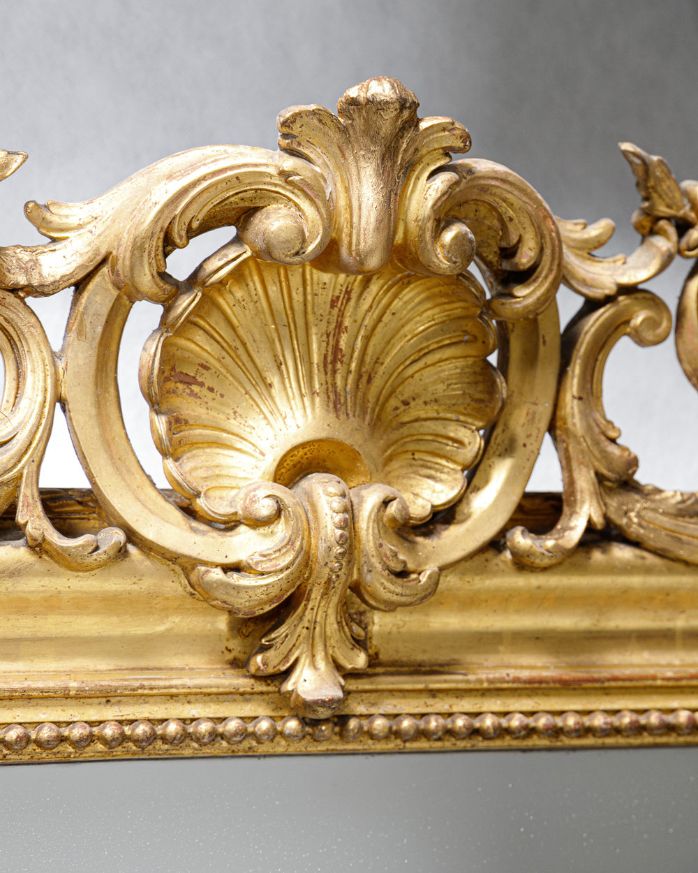Antique mirror’s ornate gold shell crest detail, part of the collection at Wildschut Antiques