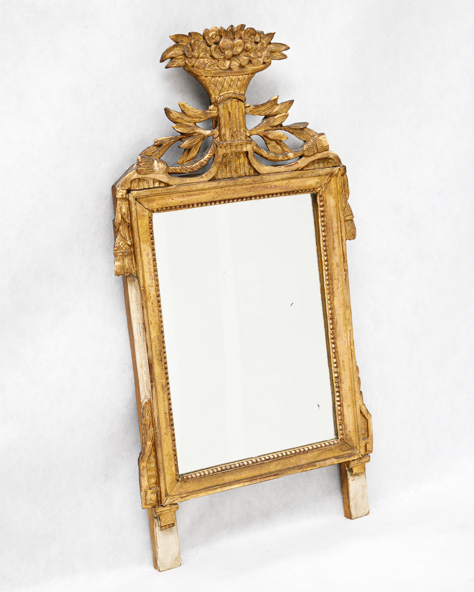 Sideview of a decorative antique French gold-framed marriage or wedding mirror with intricate design on a white background