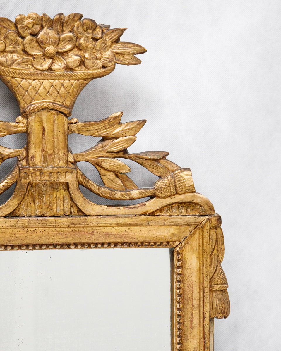 Close-up of a decorative antique French gold-framed marriage or wedding mirror with intricate design on a white background
