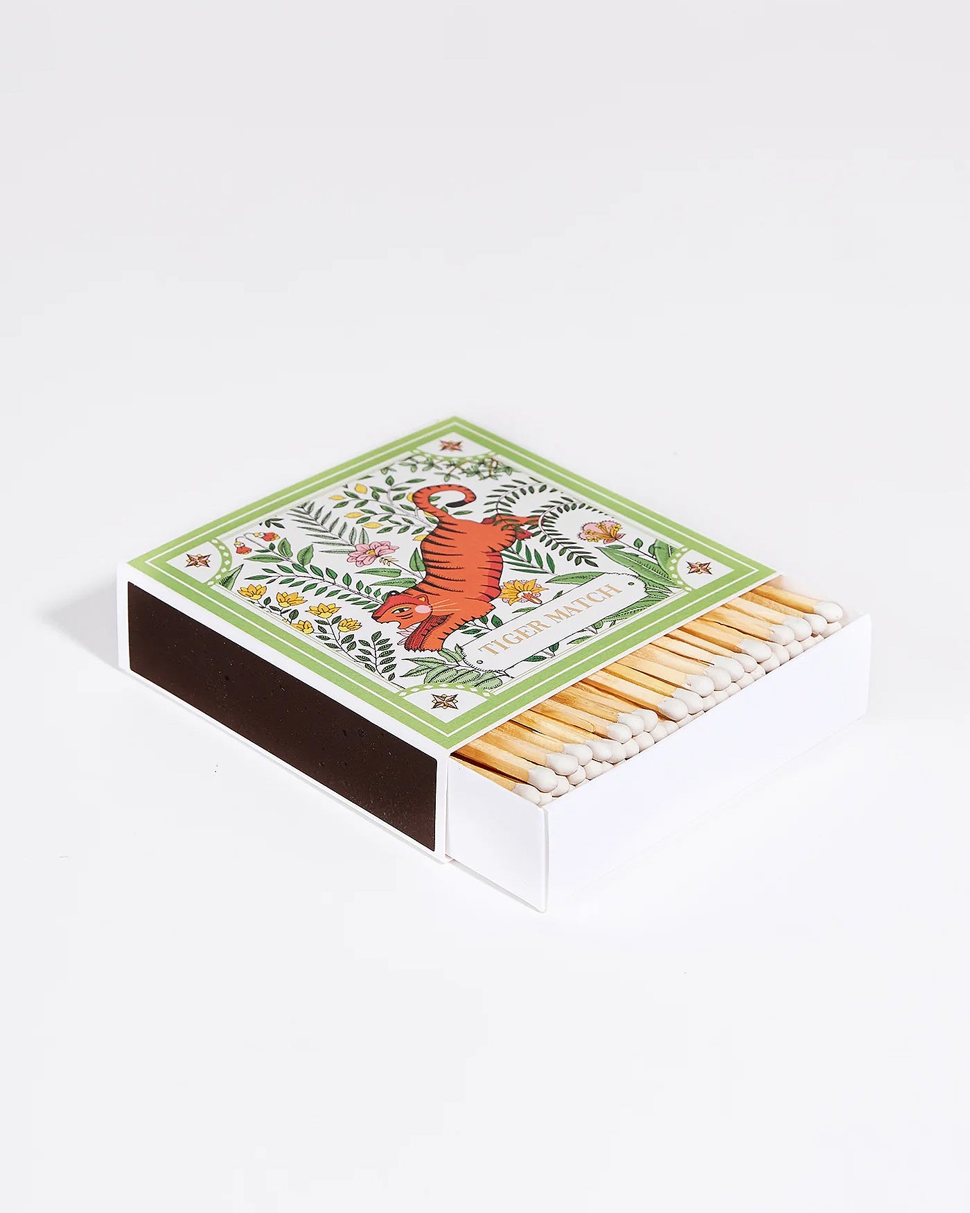 A matchbox with a green and orange tiger illustration surrounded by a botanical design. Part of the Archivist Gallery Collection, available at Wildschut Antiques.
