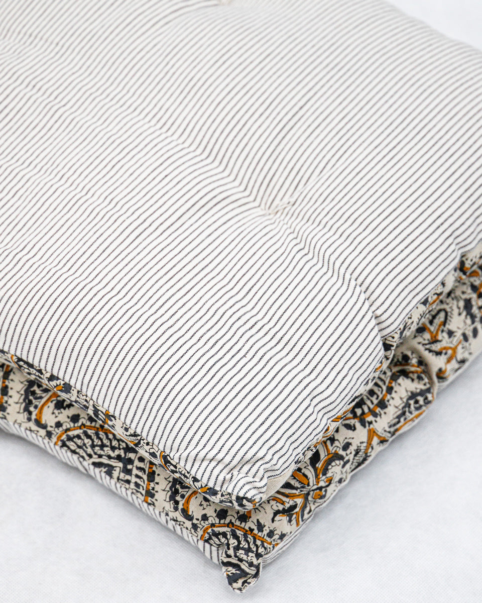 Textured pillow with small stripes on a white background