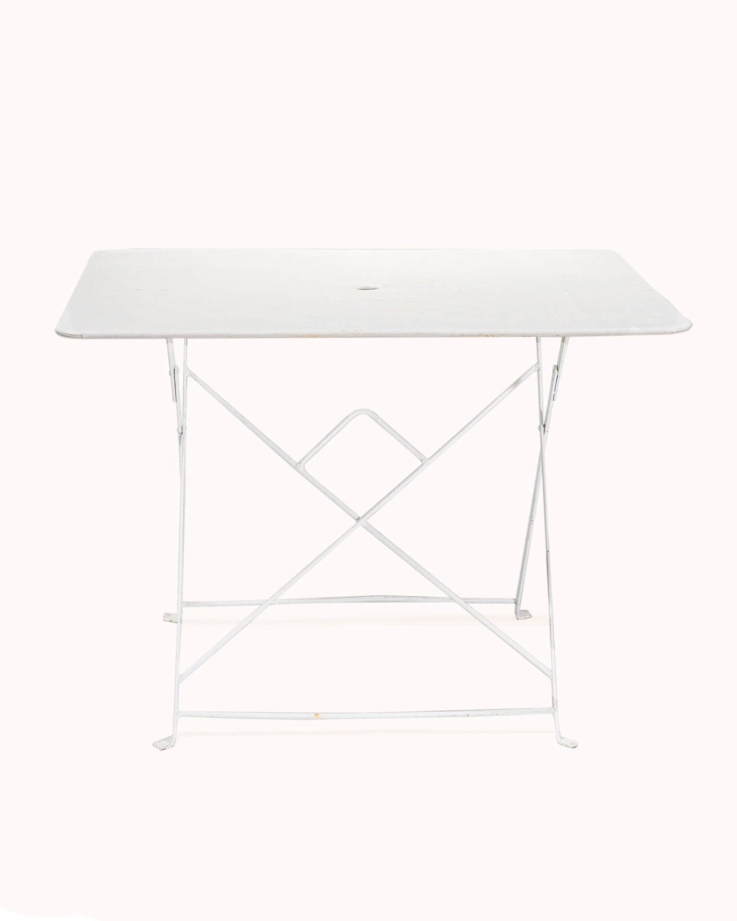 Vintage French white rectangular metal folding garden table with collapsible frame, from Wildschut Antiques, on a plain background