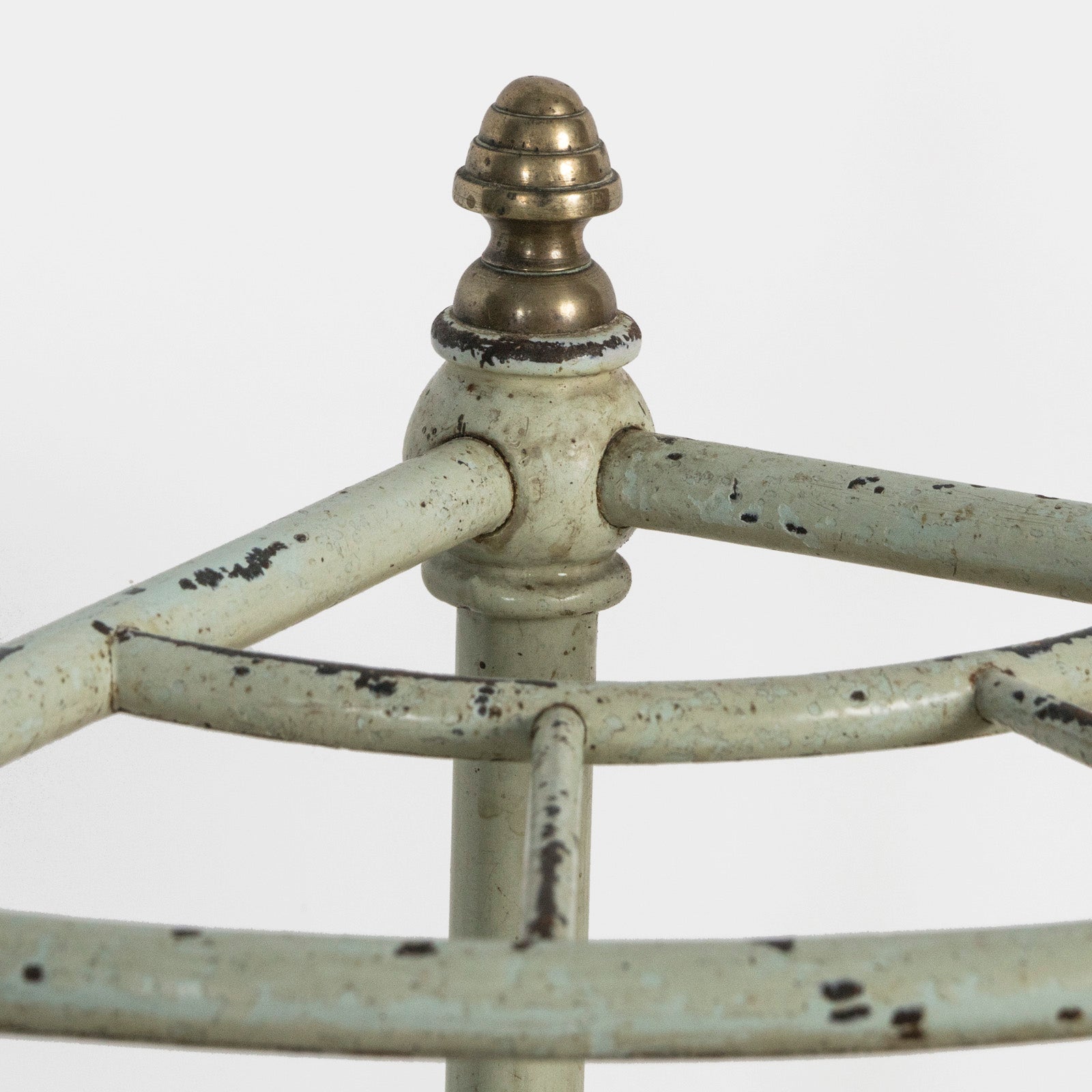 Close-up of the top brass part of an antique mint green brass and painted iron corner umbrella rack with four compartments, featuring a aged patina, available at Wildschut Antiques