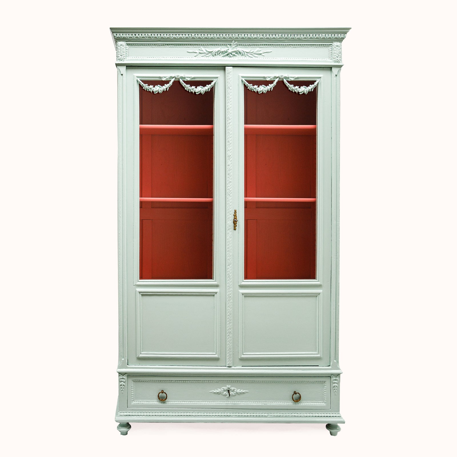 Antique French Louis XVI-style vitrine cabinet with a soft mint green finish, glass doors, and contrasting red interior, available at Wildschut Antiques