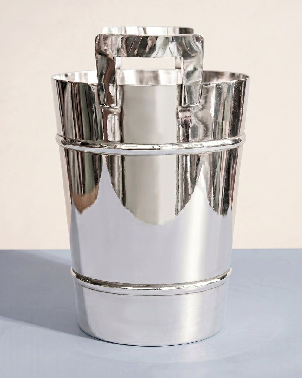 Vintage Modernist style silver plated ice bucket or champagne cooler on a light blue background, available at Wildschut Antiques.