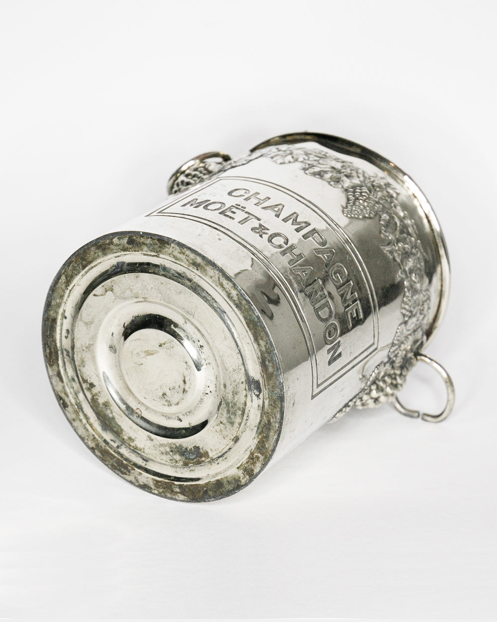 Silver champagne bottle cooler with 'Champagne Moet & Chandon' branding on a white background