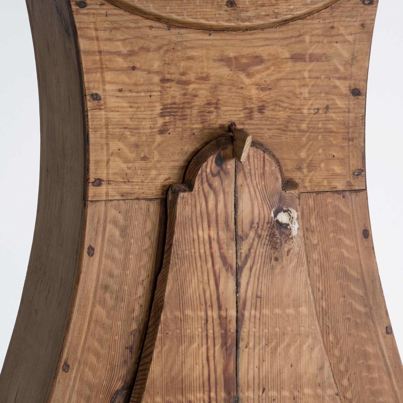 Close-up of an antique Swedish Mora clock with a natural finish, wide belly body, and a numeral face