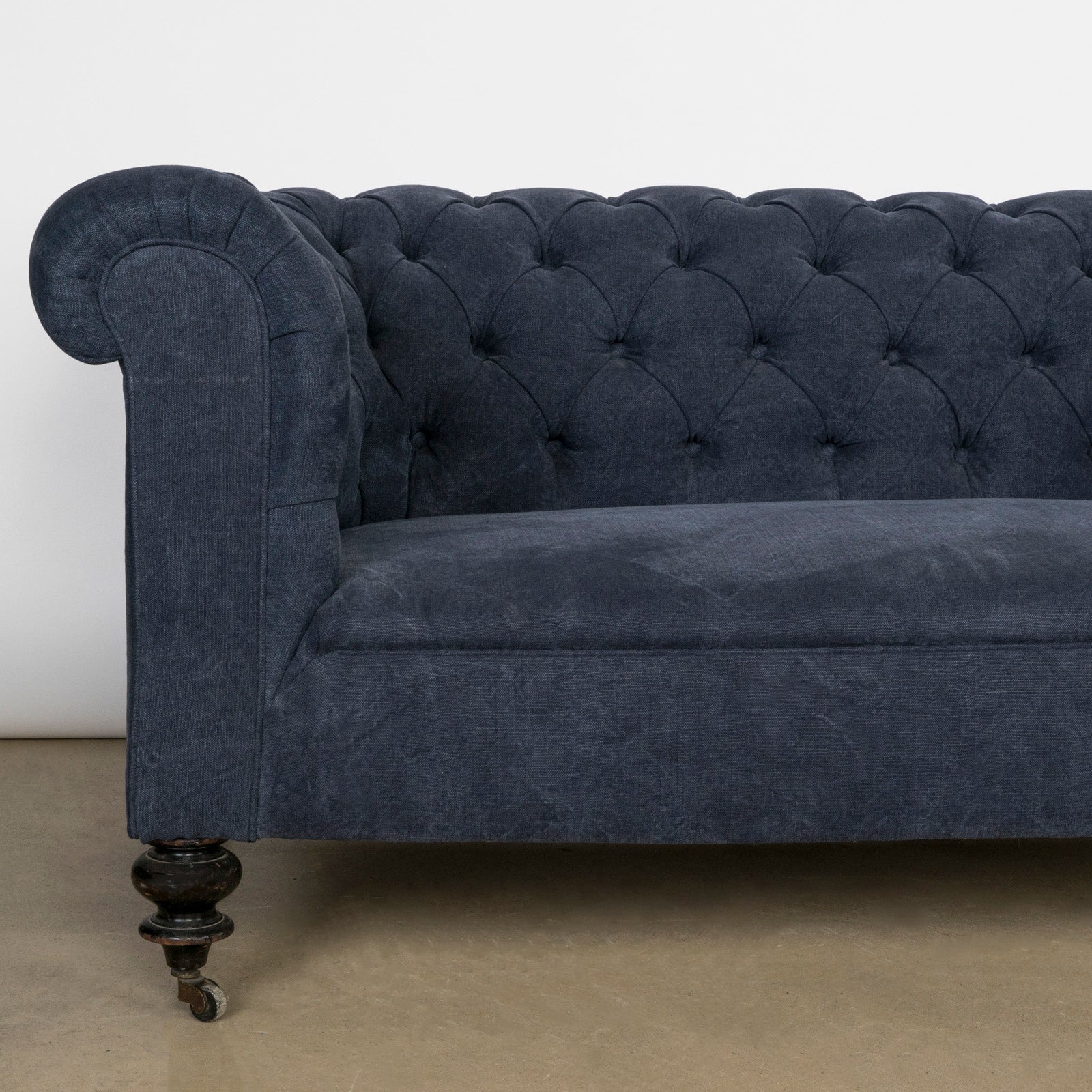 Close-up of an elegantly tufted 19th-century French Napoleon III sofa, upholstered in stonewashed blue linen—available at Wildschut Antiques.