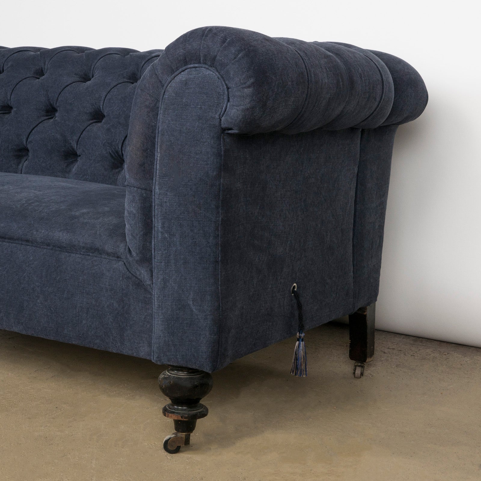 Close-up of an elegantly tufted 19th-century French Napoleon III sofa, upholstered in stonewashed blue linen—available at Wildschut Antiques.