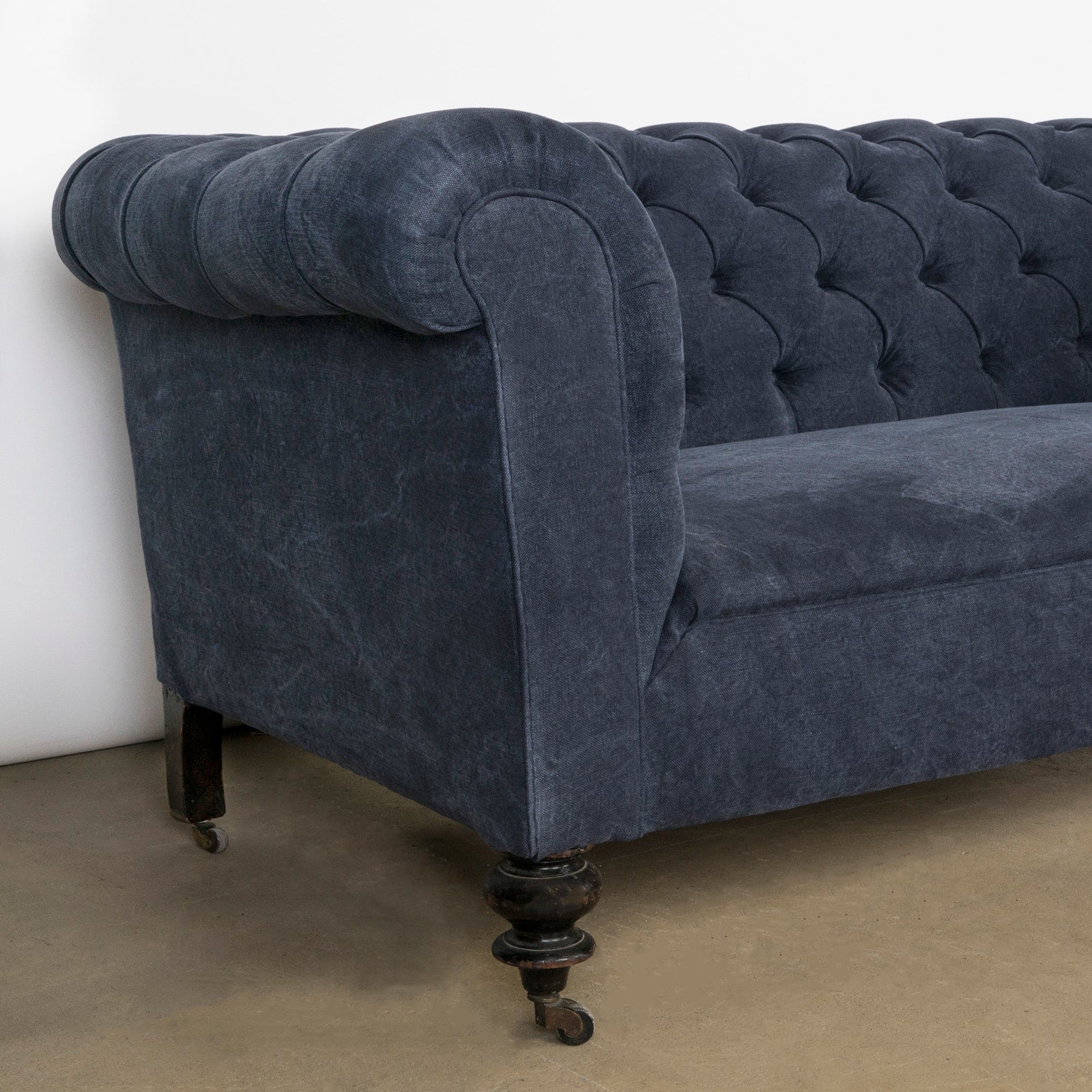 Close-up of an elegantly tufted 19th-century French Napoleon III sofa, upholstered in stonewashed blue linen—available at Wildschut Antiques.
