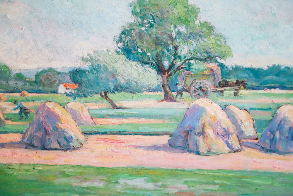 Close up of a vibrant antique French painting depicting a field with haystacks and figures working in the distance