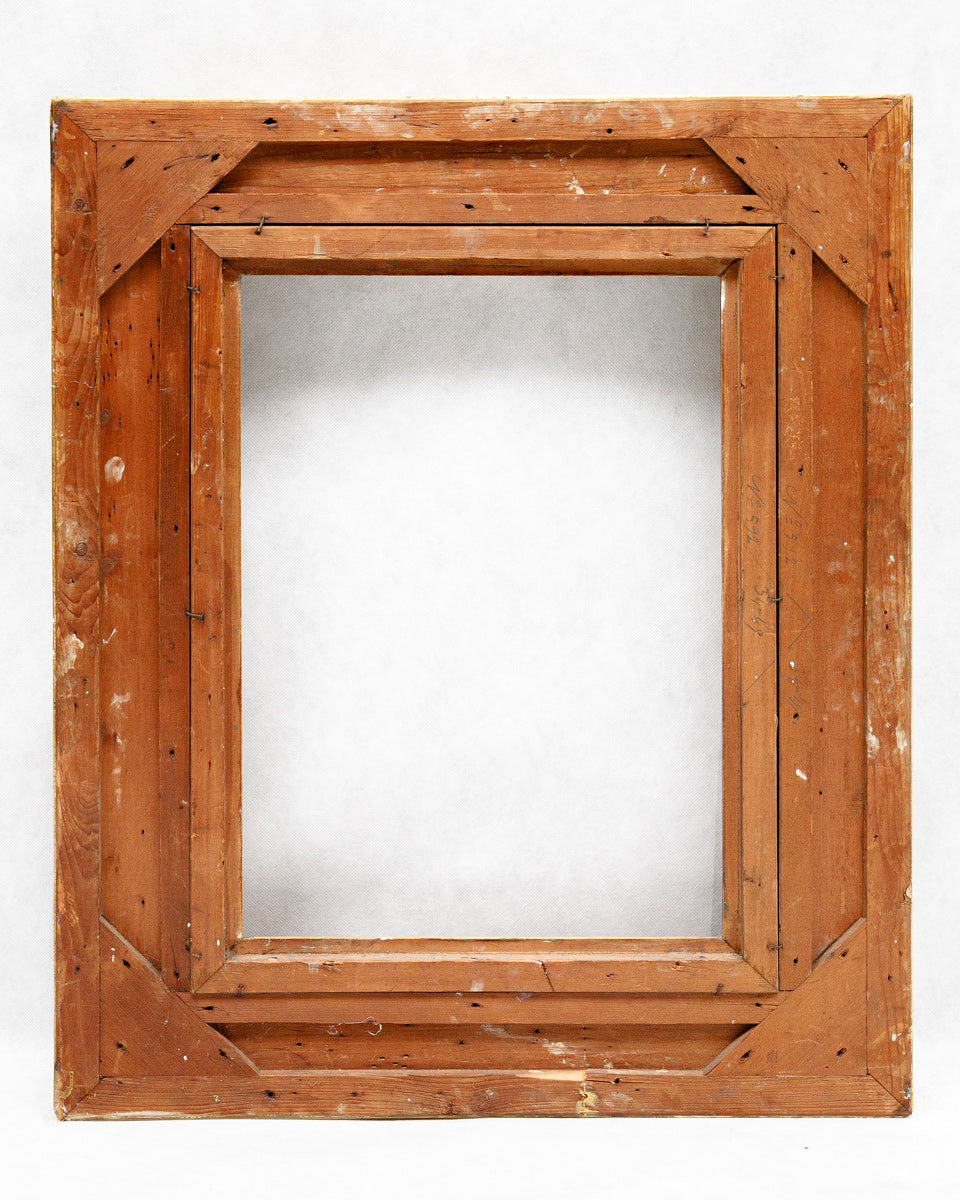 Backside of a wooden picture frame on a white background