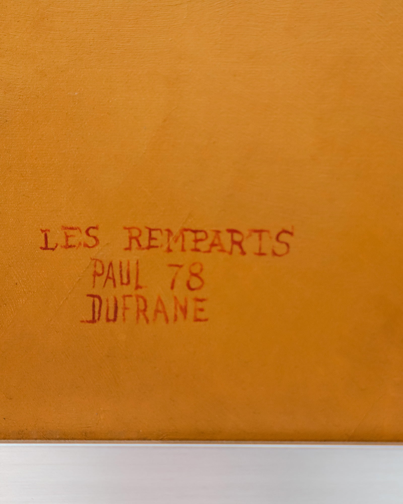Close-up of a vintage oil painting titled *Les Remparts*, a surreal cityscape signed by Paul Dufrane and dated ’78.