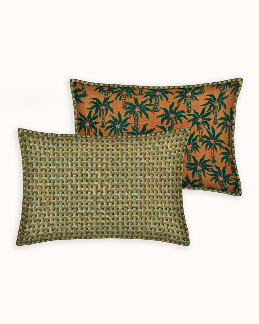 Two patterned pillows with palmtrees on a light background, by Dutch brand Palais available via Wildschut Antiques.