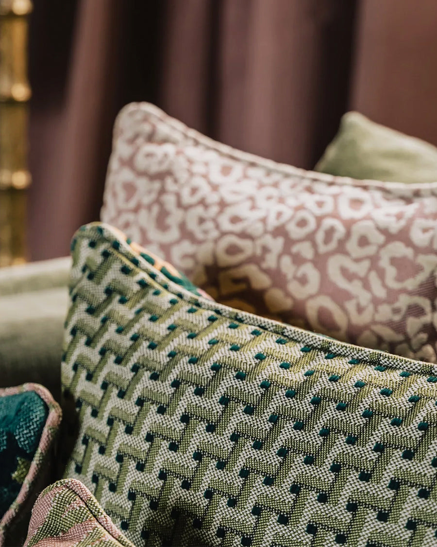 Patterned cushions on a sofa with a blurred background, by Dutch brand Palais available via Wildschut Antiques.
