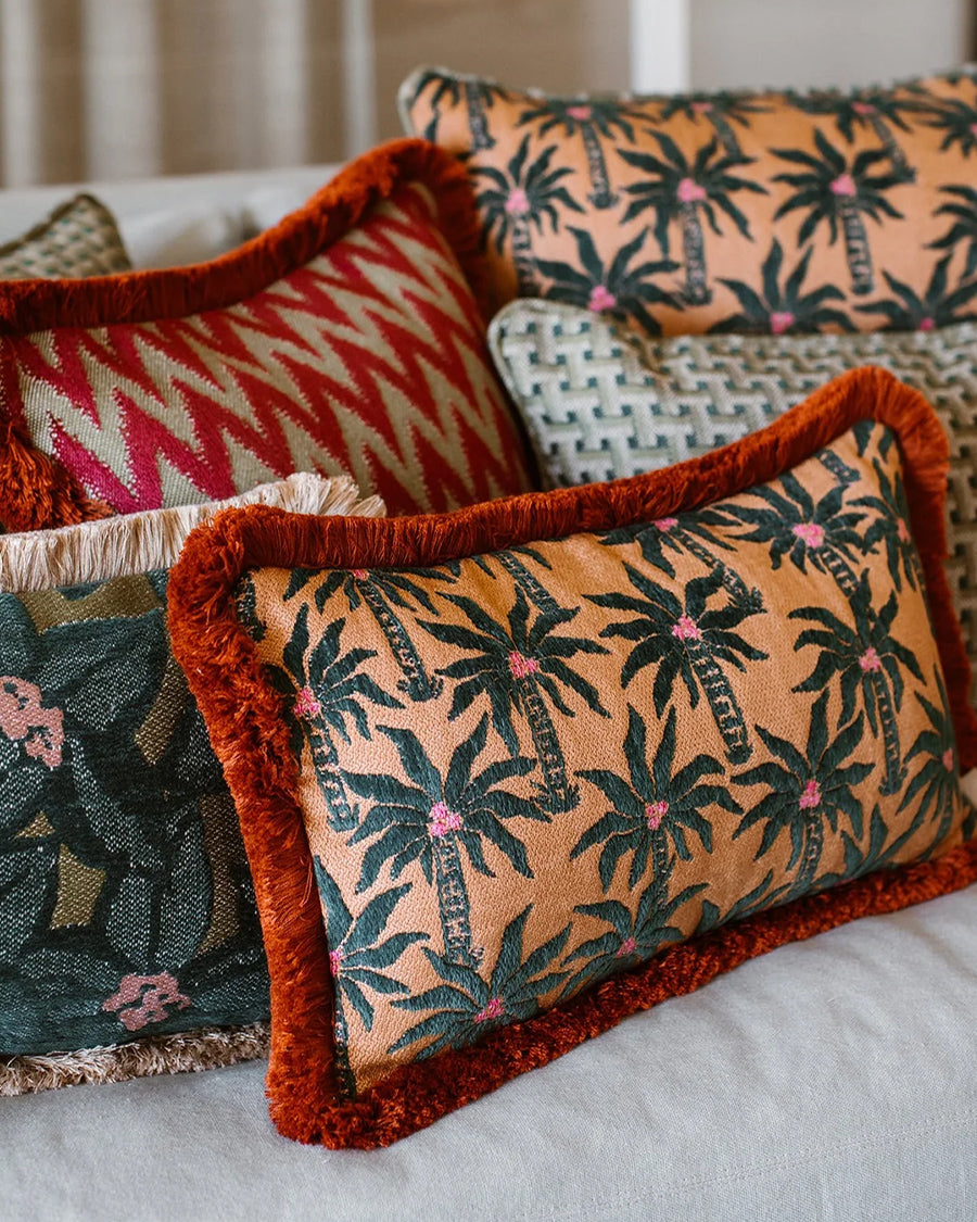 Patterned cushions on a sofa with a focus on tropical designs, by Dutch brand Palais available via Wildschut Antiques.