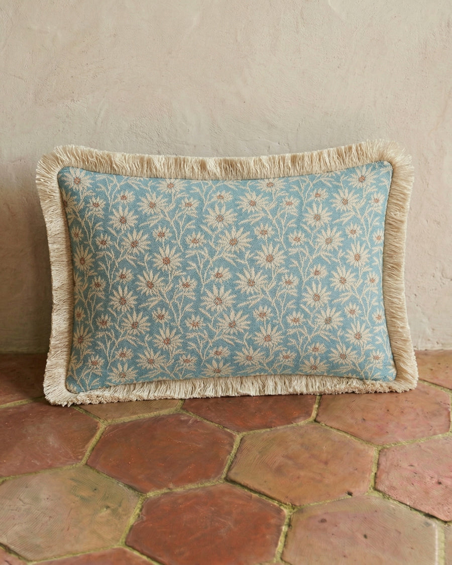 Decorative pillow with floral pattern on a stone floor, by Dutch brand Palais, available via Wildschut Antiques.