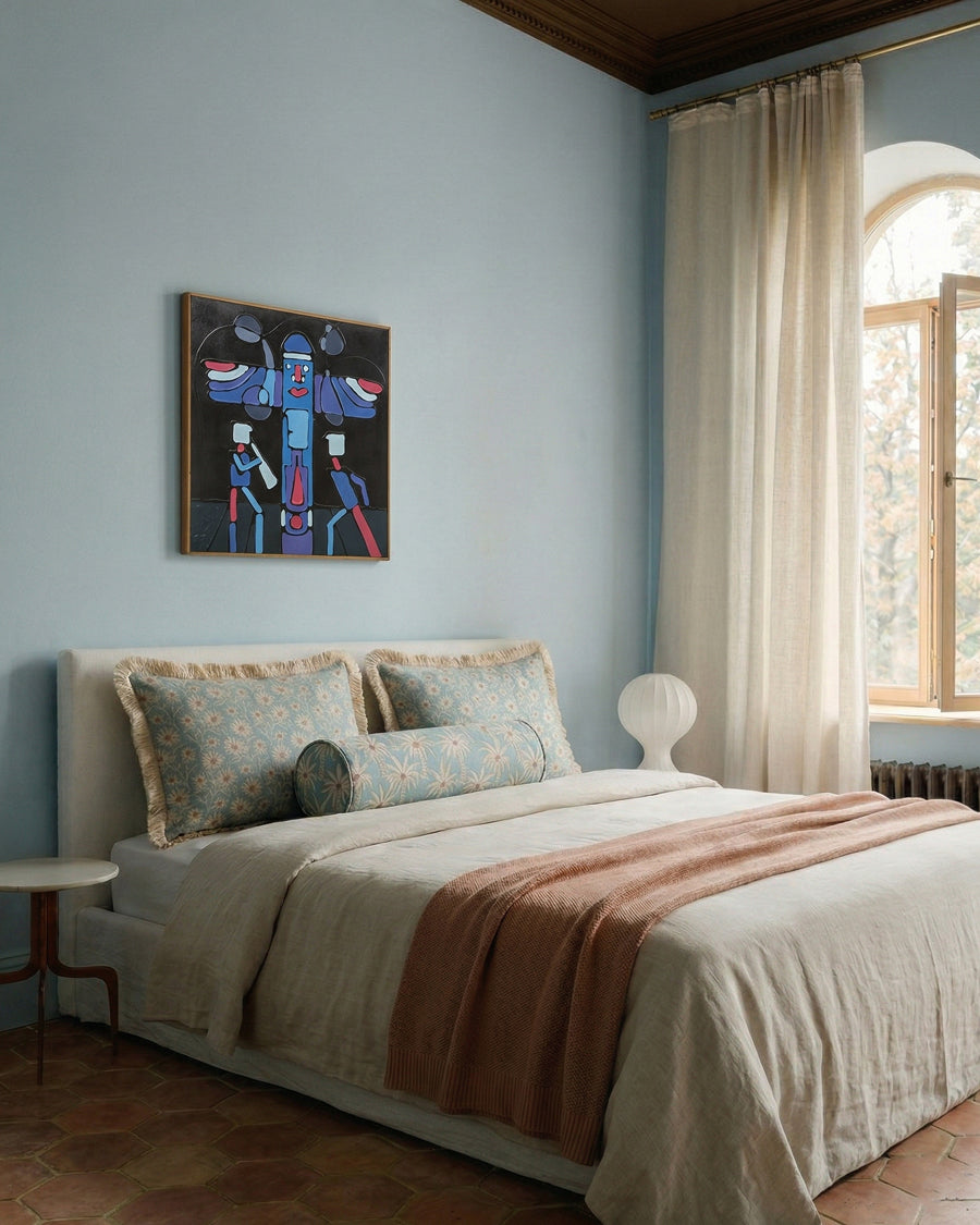 Bedroom with a bed, artwork on the wall, and large window.