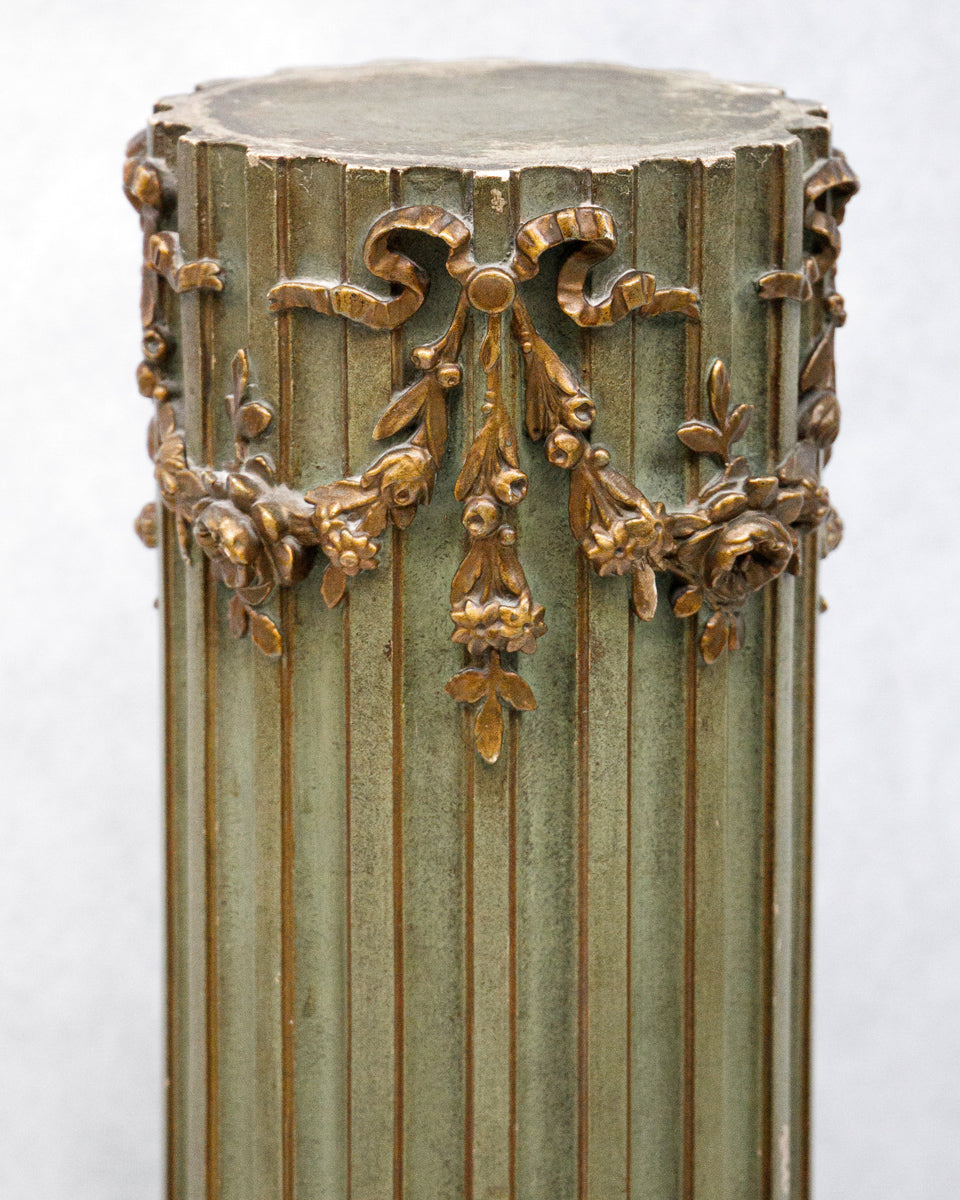 Decorative antique olive green column with gold leaf detailing on a white background available at Wildschut Antiques