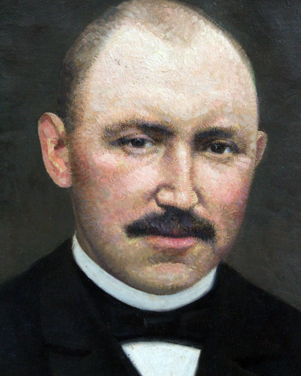 A painted portrait of a bald man with a dark mustache, wearing a black suit and white shirt against a dark background.