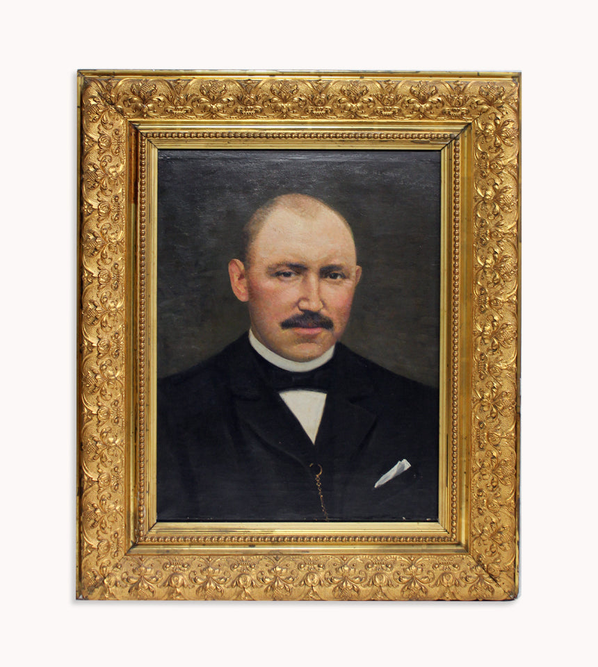 Antique oil portrait of a gentleman with a moustache, bald head, and dark suit, expertly painted by W.N. Hendrikse, in a giltwood frame, set against a clear background. Available at Wildschut Antiques.