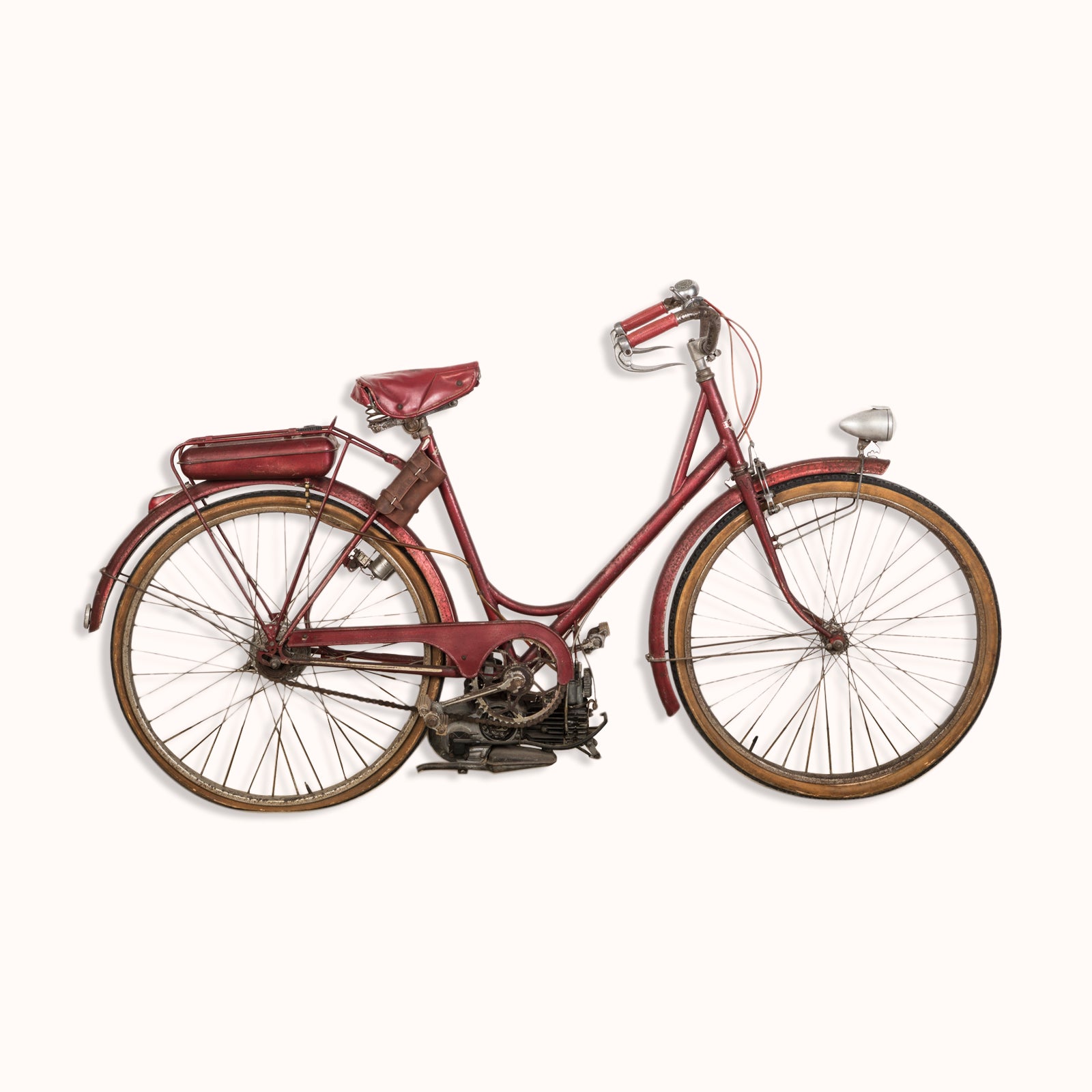 A vintage French Mobylette motorcycle with a red body and red seat, featuring a patina finish and original mechanisms, available at Wildschut Antiques