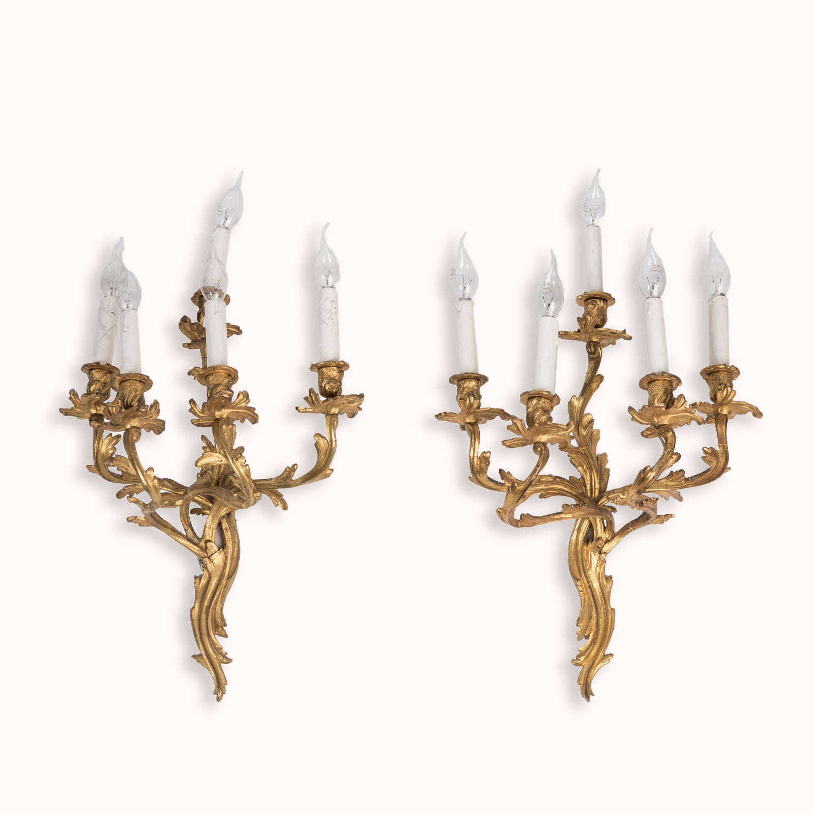 Set of two grand 19th-century French Rococo five-light sconces, crafted from richly gilded bronze, shown against a clean background. Available at Wildschut Antiques.
