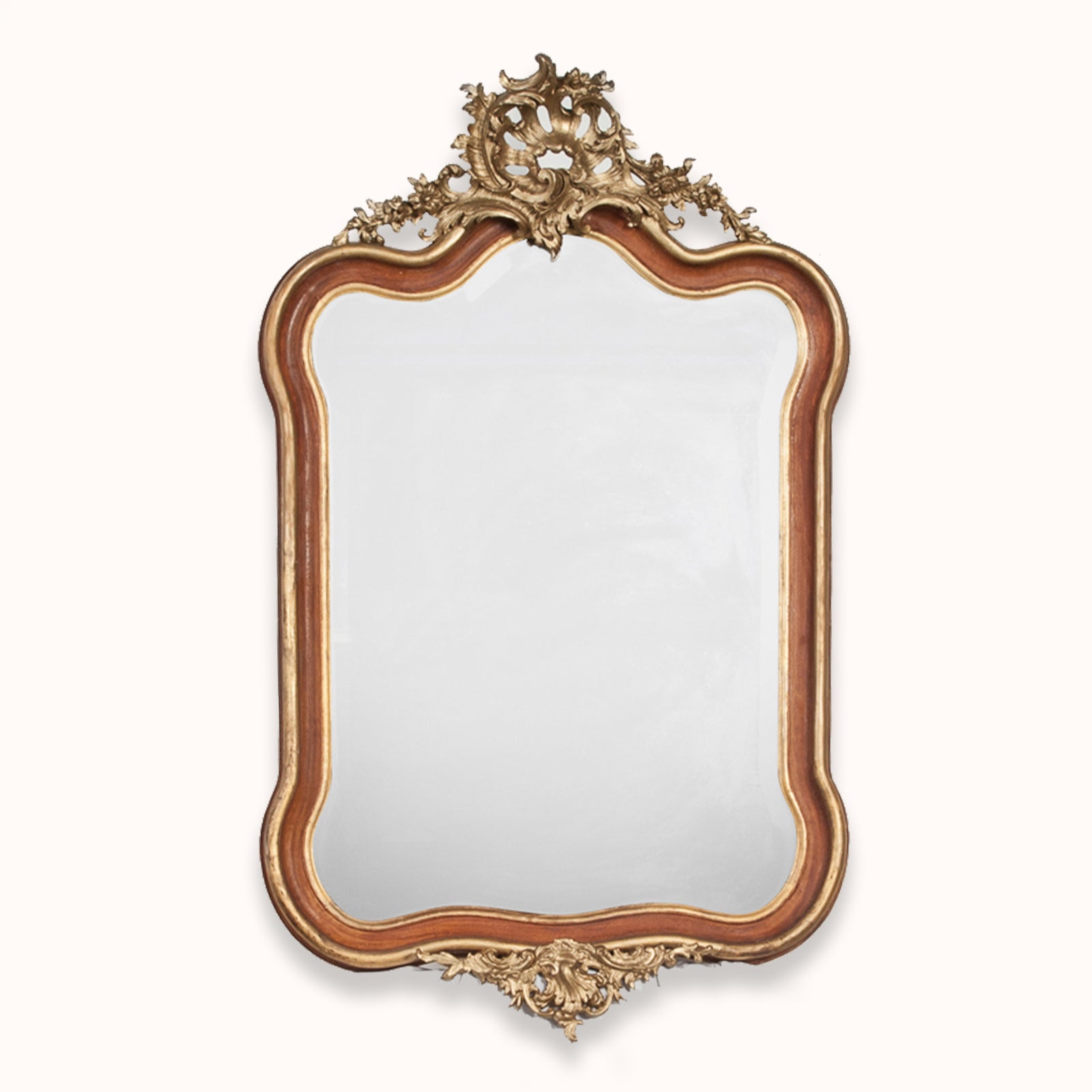 A 19th century Italian Rococo style gilt wood mirror with floral decoration and a scalloped shell in the frame, available at Wildschut Antiques