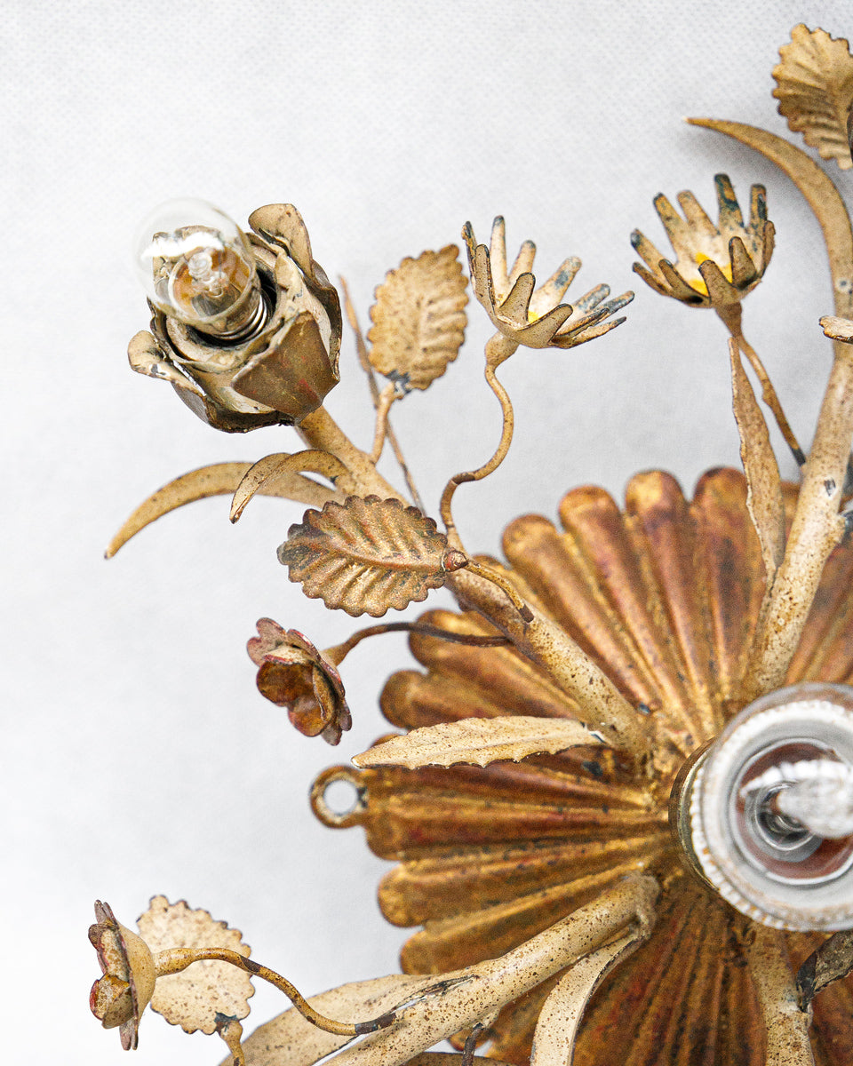 Close-up of a decorative tole wall sconce or ceiling light with floral designs on a white background available at Wildschut Antiques