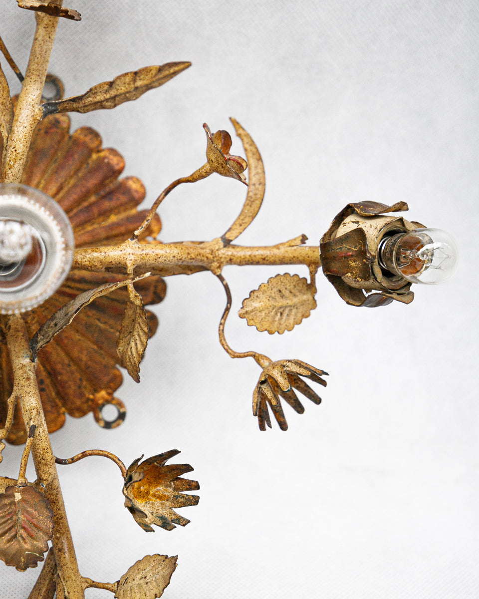 Close-up of a decorative tole wall sconce or ceiling light with floral designs on a white background available at Wildschut Antiques