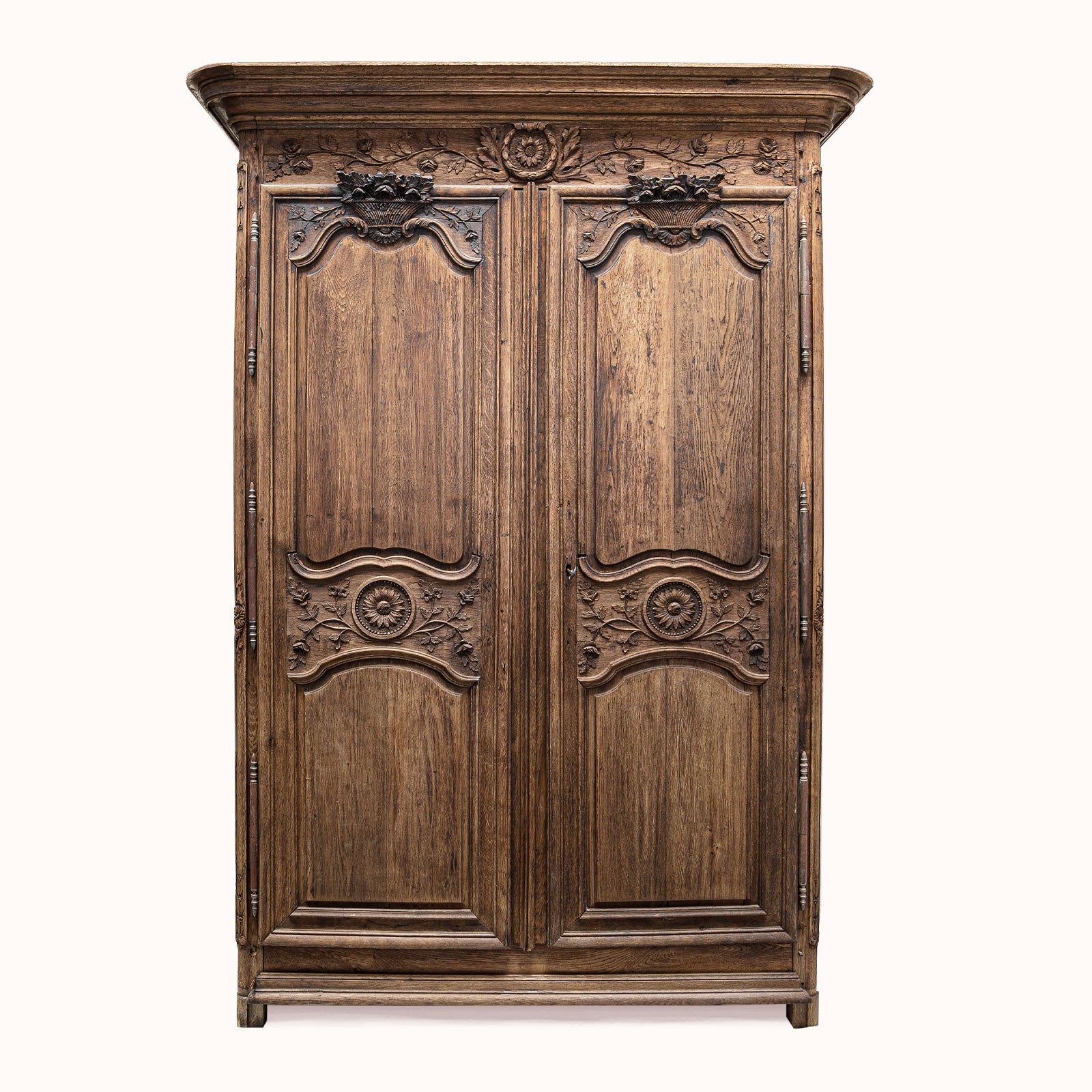 Antique French wooden armoire or marriage wardrobe featuring intricate carvings, shown against a white background - Wildschut Antiques Collection