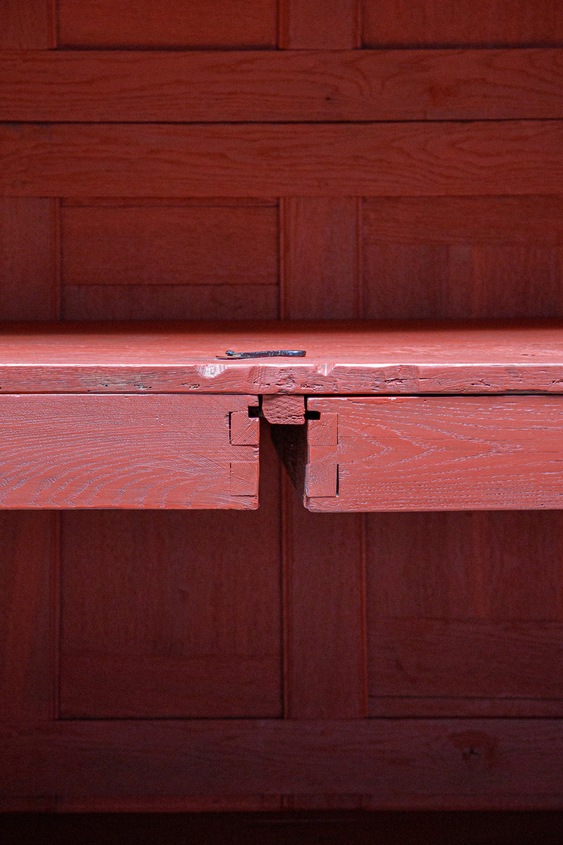 Close-up of a red wooden interior of an antique French cabinet or armoire with two drawers.