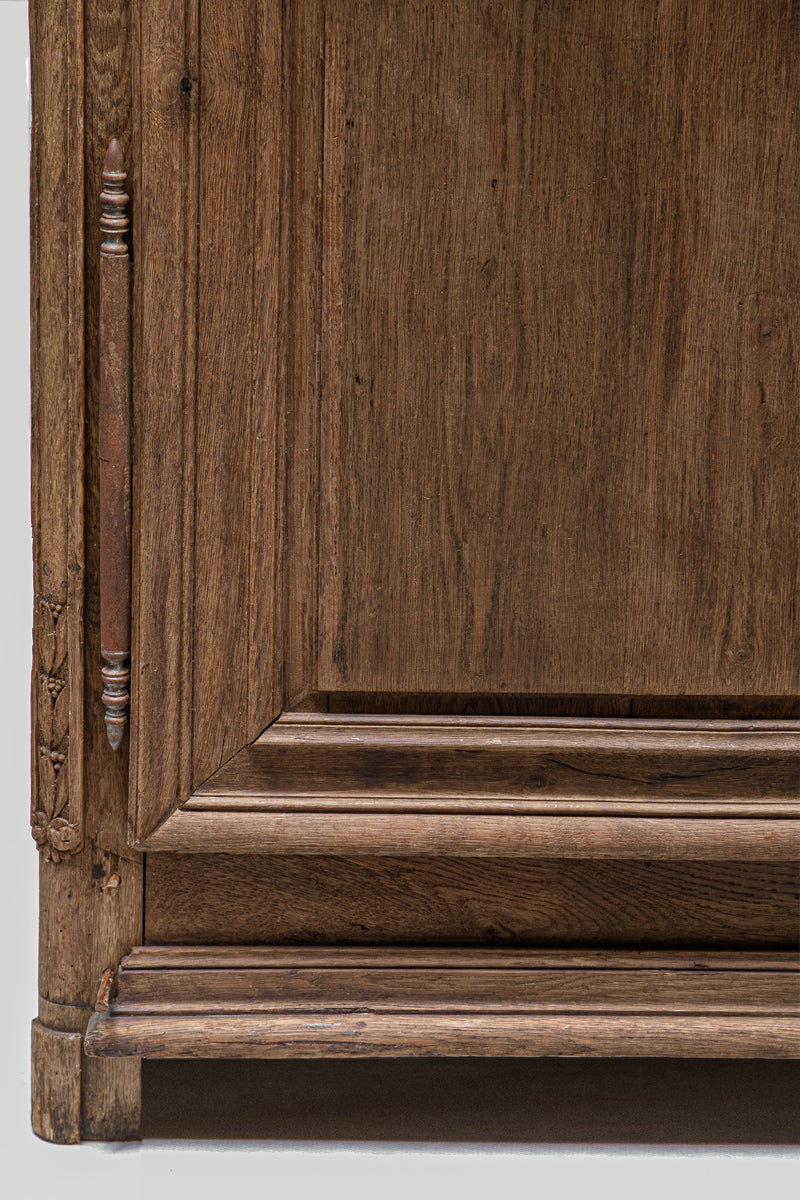 Close-up of a wooden cabinet with intricate carvings on a white background