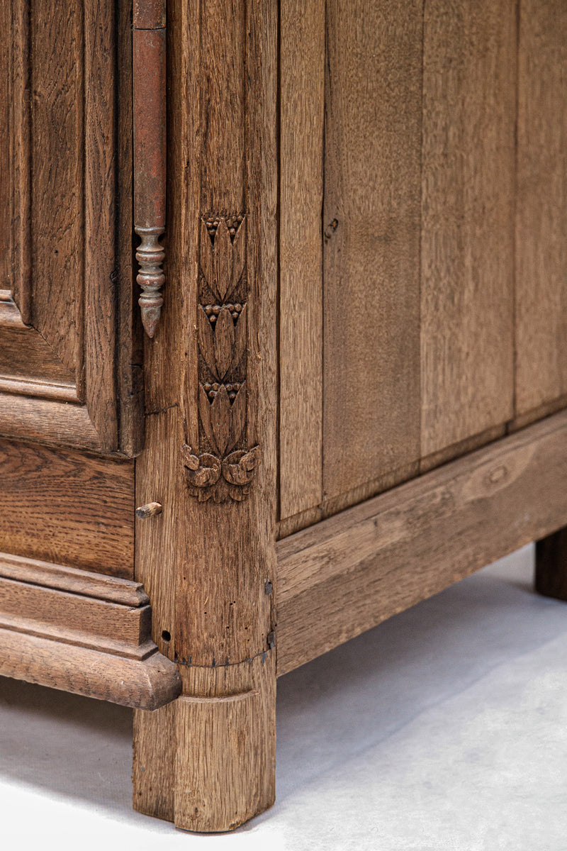 Close-up of a wooden cabinet with intricate carvings on a white background