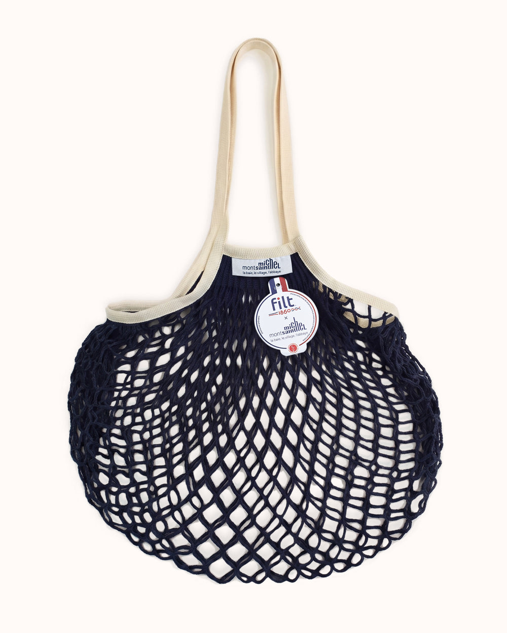 Navy blue mesh bag with beige handle on a white background. By Filt 1860 x Mont St. Michel, available at Wildschut Antiques.