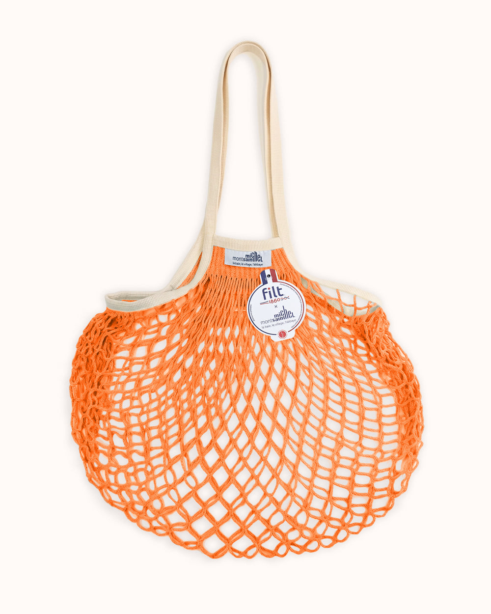 Orange mesh bag with a white handle on a white background. By Filt 1860, available at Wildschut Antiques.