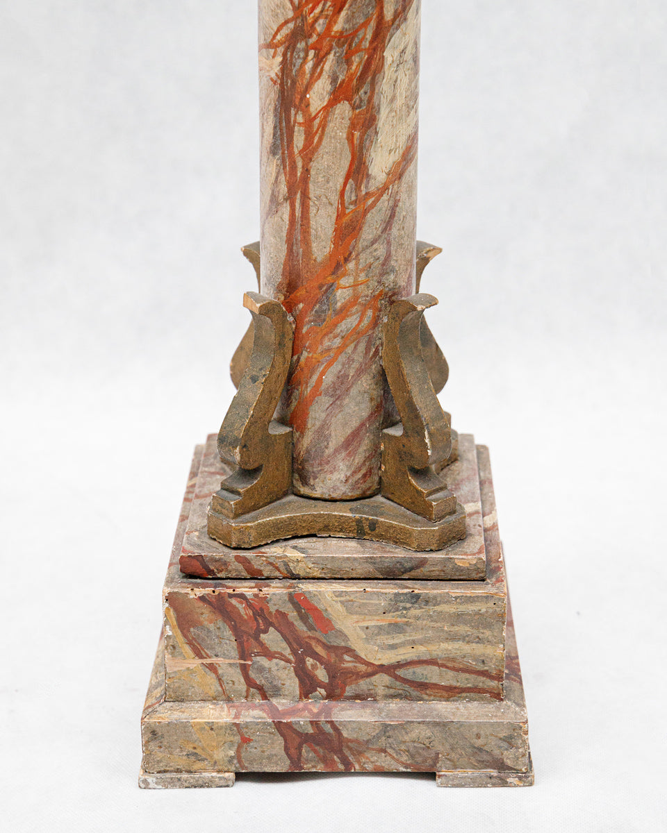 Decorative wooden column with marble-like design on a white background