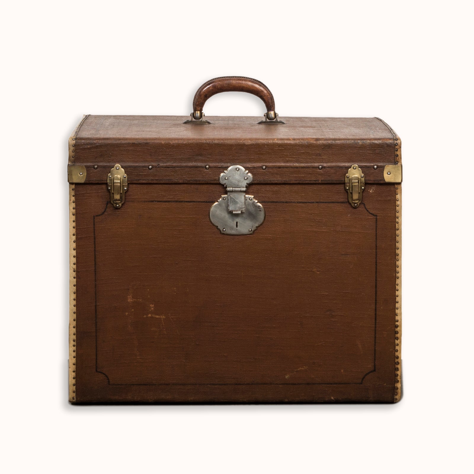 A brown vintage canvas cube-shaped trunk with a leather handle and metal accents, available at Wildschut Antiques