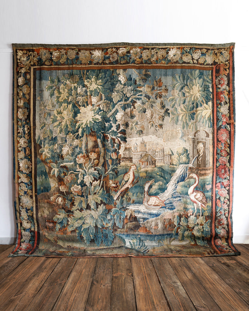 Decorative 18th-century Verdure tapestry with floral and bird design on a wooden floor - Wildschut Antiques Collection