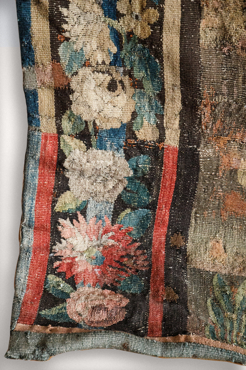 Close-up of a corner of a 18th-century floral tapestry with intricate details