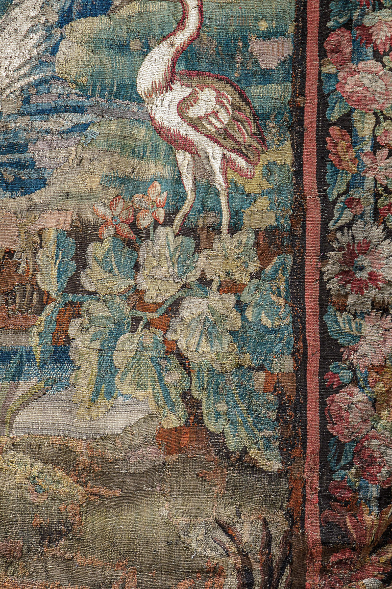 Close-up of a decorative 18th-century Verdure tapestry with birds, leaves and nature