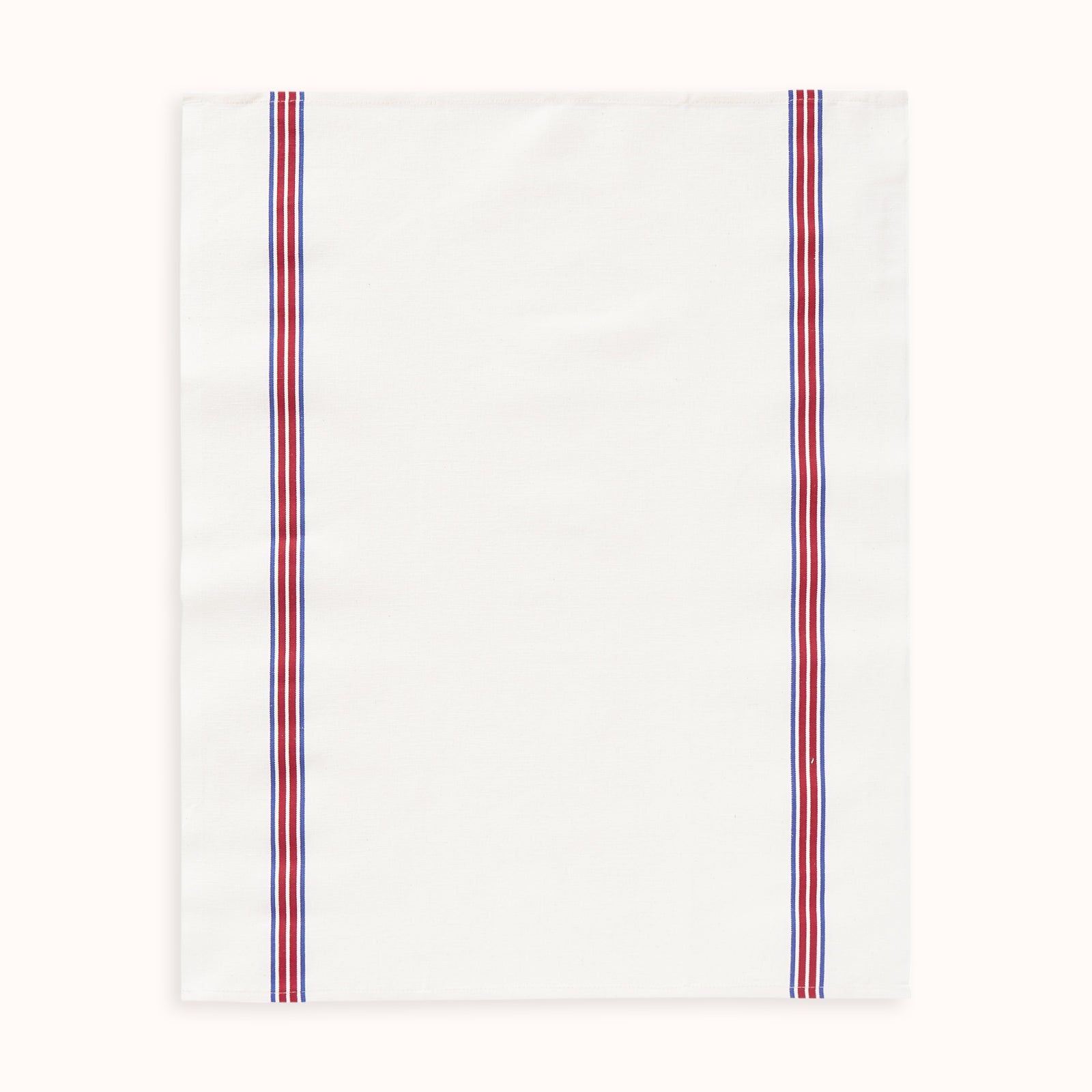 A white dish towel with blue and red stripes on the sides by Charvet Editions available at Wildschut Antiques