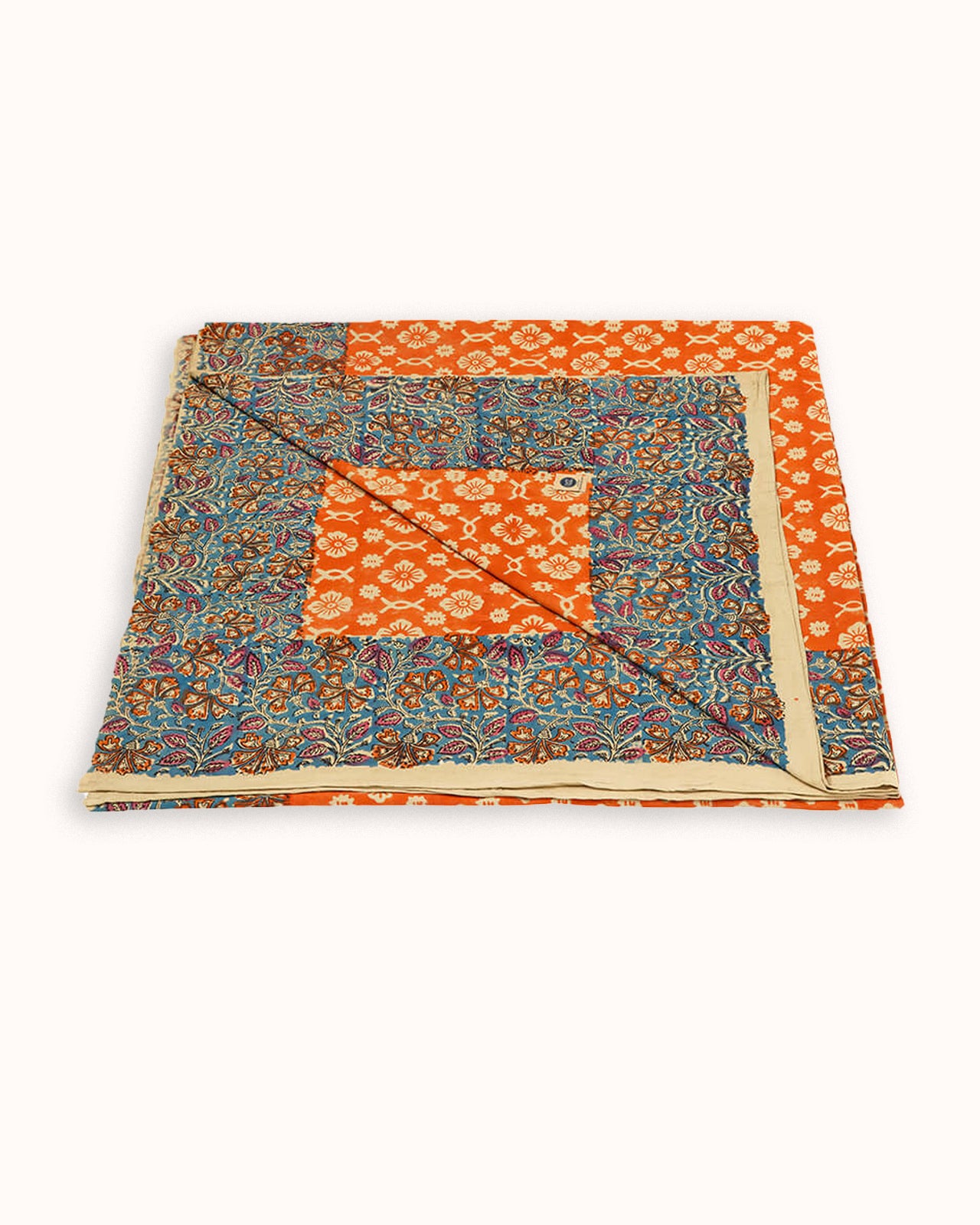 Folded fabric with orange and blue pattern on a white background