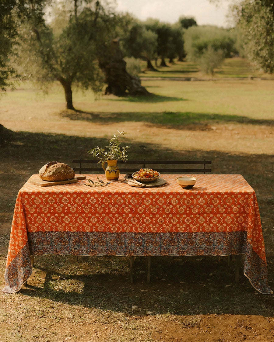 Table set with food and a plant under an olive tree
