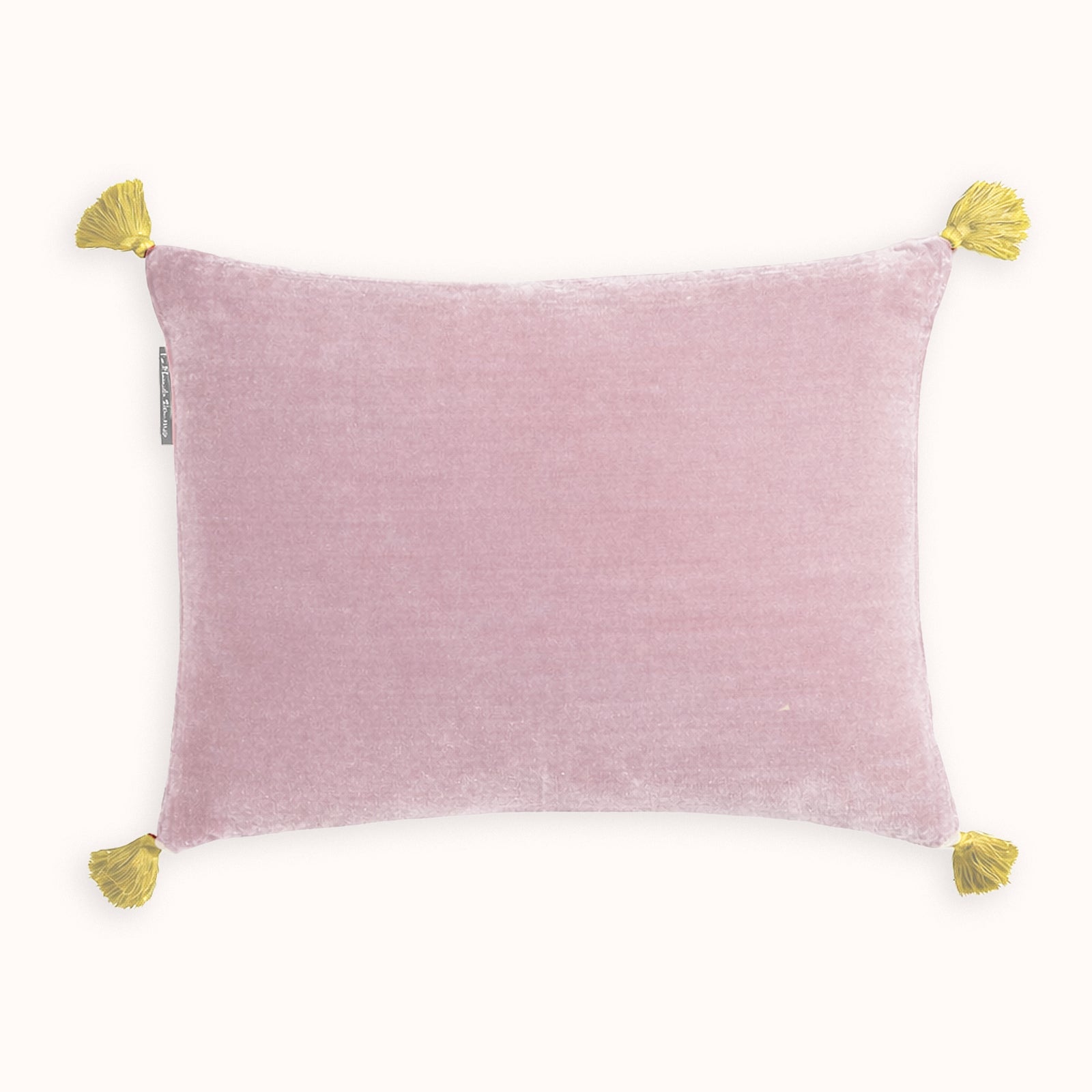 Soft pink silk velvet velour cushion with contrasting yellow pom-pom tassel details on a white background. Designed by Monde Sauvage Paris, available at Wildschut Antiques.
