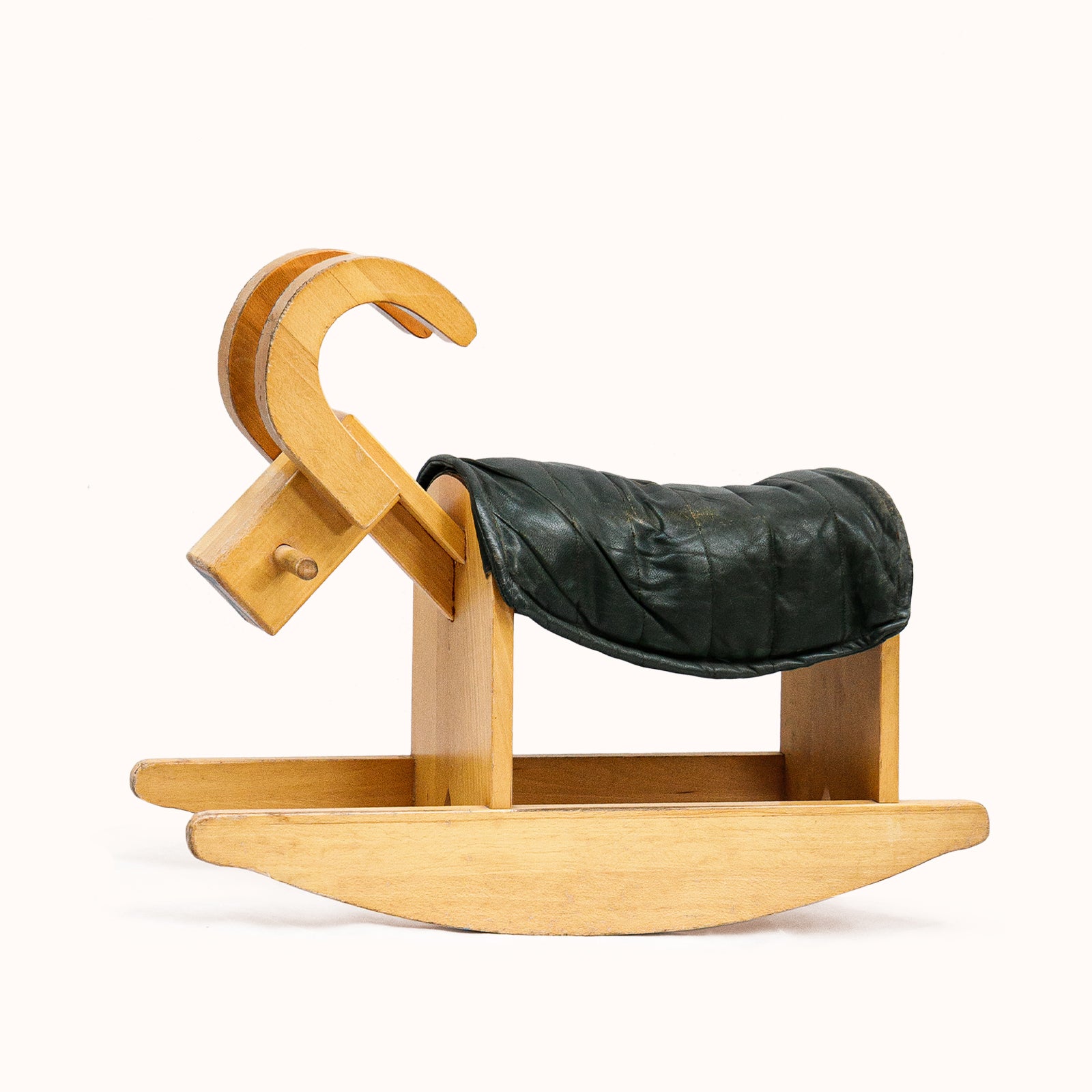 A vintage wooden rocking billy goat with a dark green leather deck, showing age-appropriate wear, available at Wildschut Antiques