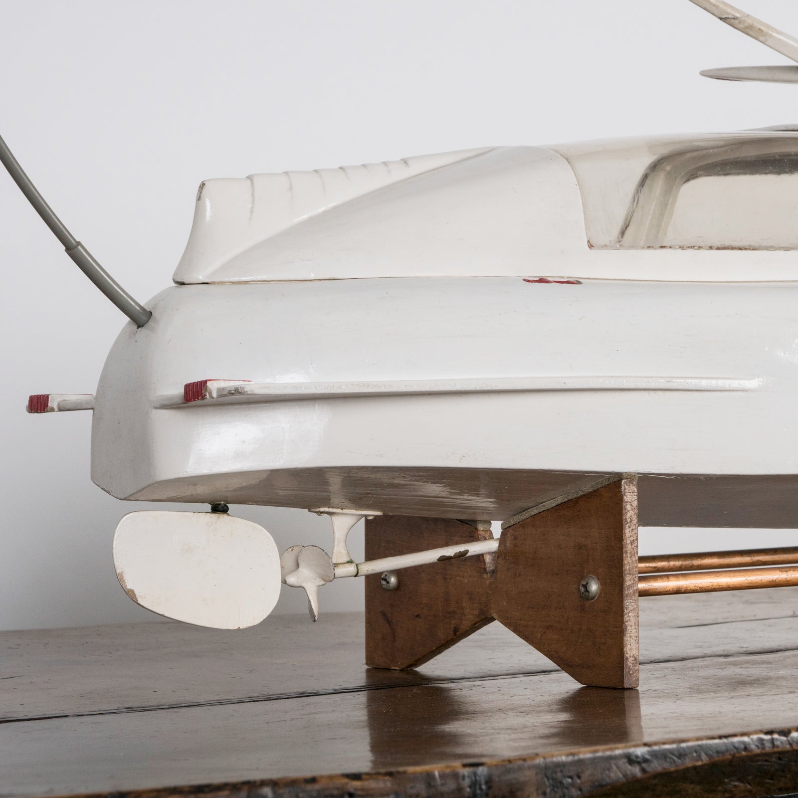 Close-up of a superb vintage French scale model of a speed boat, meticulously handcrafted to replicate the iconic Plymouth motorboat. Made from light-toned wood with fine detailing, this elegant piece captures nautical charm at its best. Available at Wildschut Antiques.